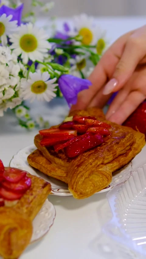 Flaky puff pastry filled with fresh strawberries and strawberry jam on white Stock Footage 344894044