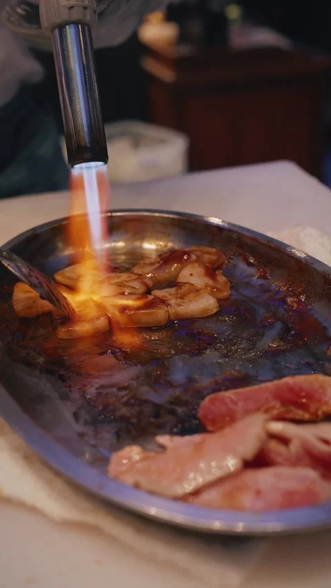 Flambeing squid slices with eel sauce – 4K vertical video Stock Footage 315565030