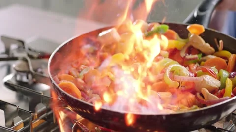Flambing chicken and vegetables Stock Footage 46456448