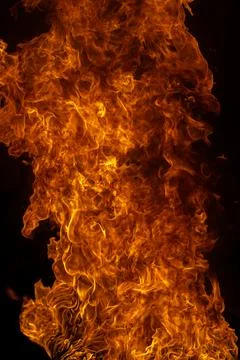 Flame background glows on black. Flame background creates hot texture. Burning Stock Photos