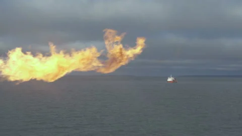 Flame on background of sea. Rescue ship on horizon. Fire against sky Stock Footage 205415304