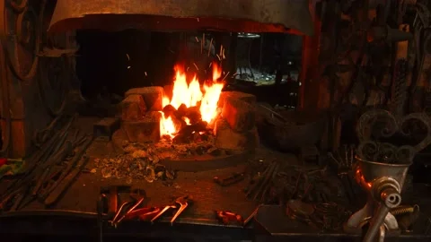 The flame of the blacksmith's hearth. blacksmith's workplace. blacksmith tools. Stock Footage 220500795