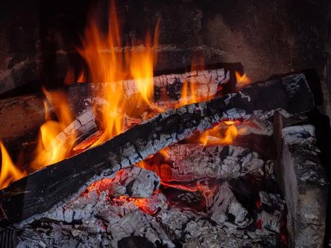 Flame of burning coal in the fireplace Stock Photos