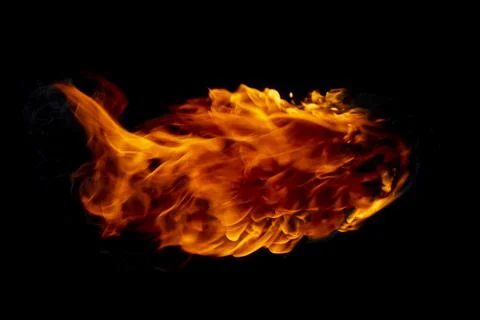 Flame of burning fire going through a black background Stock Photos
