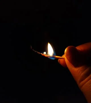 Flame of a burning match close-up Stock Photos