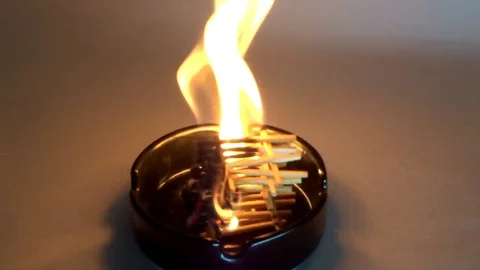 Flame of burning matches in an ashtray Stock Footage 94953292