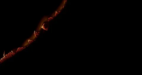 The flame of a burning paper moving from the left to the right side Stock Footage 98528212