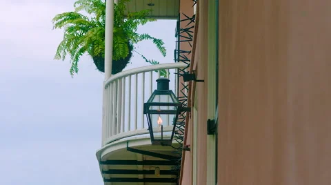 Flame burning, Slo mo, on side of peach building, white balcony behind, French Q Video stock 53362681