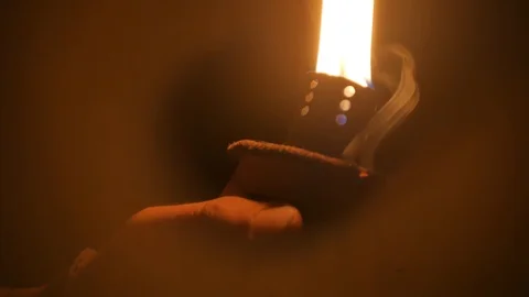 Flame of a burning torch. In the dark. Movement of the torch. A torch in  hand. Stock Footage 97972742