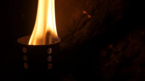Flame of a burning torch. In the dark, stone wall Stock Footage 97768526