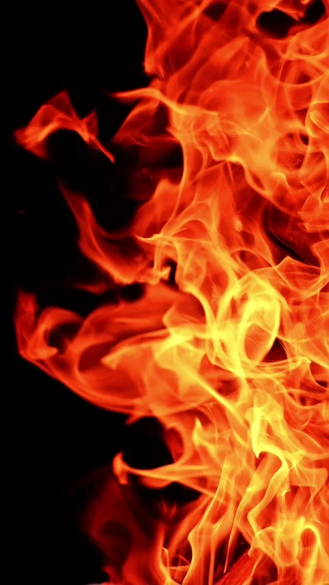 Flame of a campfire leaning to the side. Isolated bonfire burning at night. Stock Footage 337715691