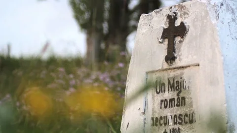 Flame candle burning in front of a cross placed on the grave of an unknown he Stock Footage 91921174