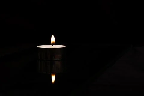 Flame of candle close up, isolate on black background Stock Photos