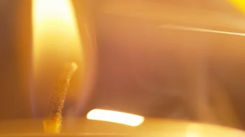 The flame of a candle lights up the fuse of a dynamite bomb or firecracker Stock Footage 123986428