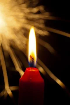 Flame of a candle with a sparkler Stock Photos