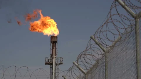 Flame from chimney. Barbed wire. Associated petroleum gas. Oil Field. Fire from Stock Footage 178983008