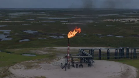 Flame from a chimney on a tundra background. Torch burns. Aerial view Stock Footage 295037737
