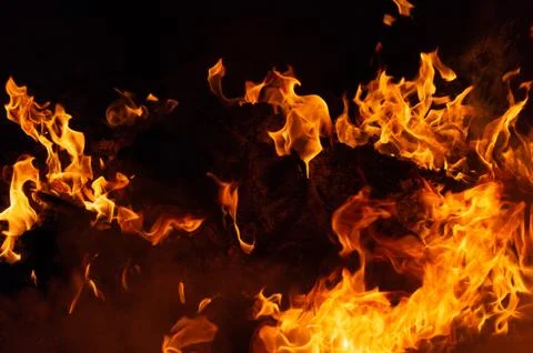 Flame of fire on a black background Stock Photos