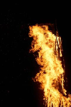 Flame of fire on a black background. Vertical photo Stock-Fotos