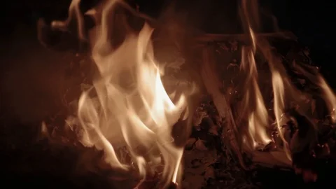Flame of fire burns pile of documents associated with war and destruction Stock Footage 117994434