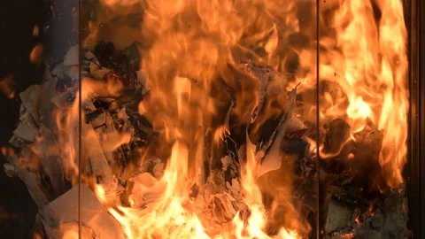 The flame of the fire in the fireplace burns paper or documents, close-up. Stock Footage 230426326