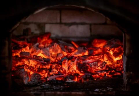 Flame of fire from hot burning coals in the fireplace. Heat from the oven. 스톡 사진