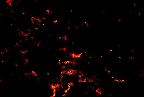 Flame of fire with sparks on a black background Stock Photos