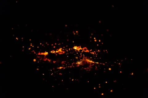 Flame of fire with sparks on a black background Stock Photos