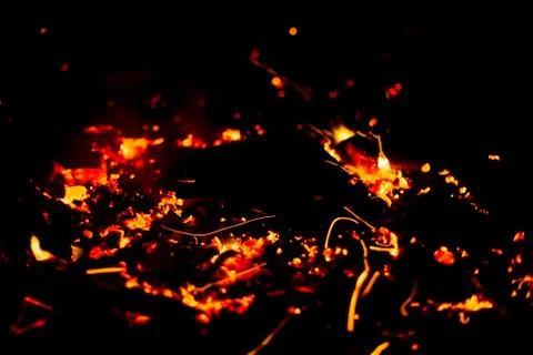 Flame of fire with sparks on a black background Stock Photos