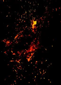 Flame of fire with sparks on a black background Stock Photos