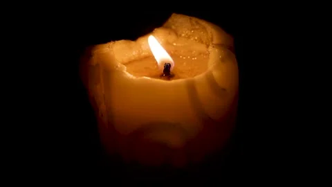 Flame flickers gently consuming wax slowly melting downward Stock Footage 331726275