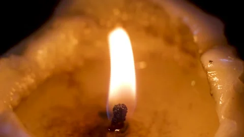 Flame flickers gently consuming wax slowly melting downwards now Stock Footage 331726282