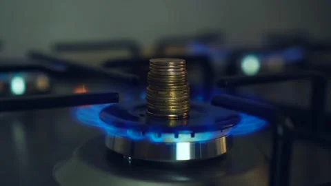 Flame gas burner operation, fire on stove with stack of coins Stock Footage 208865573