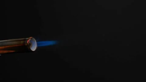 Flame from the gas burner pipe coming out of the nozzle, on a black background. Stock Footage 200095562