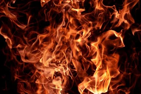 Flame glowing texture with sparks. Flame burning dark background. Flame abstract Stock Photos
