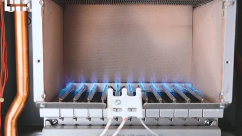 Flame ignites inside the combustion chamber of gas boiler. turning on heating Stock Footage 326917211