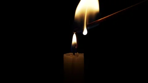 Flame Ignites Matchstick in Dark Room Creating a Warm Glow Stock Footage 289497485