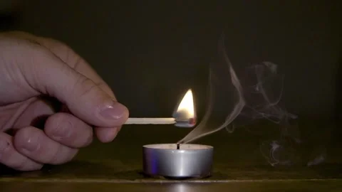 Flame jumps from match to candle Stock Footage 137459406