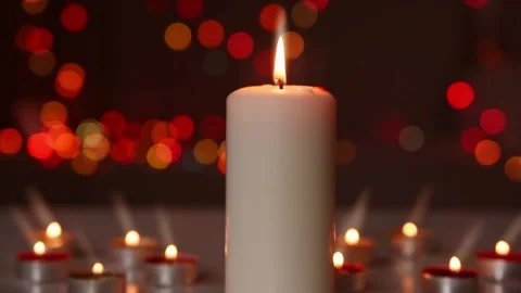 Flame of large burning candle,against  red lights backround. Footage HD. Stock Footage 148138972