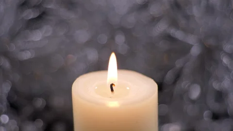 Flame Of A Lit  Candle with Silver Background, Christmas Decoration Video stock 128822358