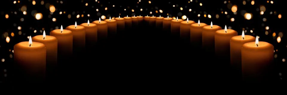 The flame of many white candles on a black background with a Golden bokeh Stock Photos