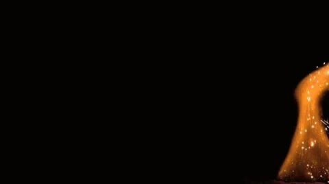 Flame moving to centre of screen on black background Stock Footage