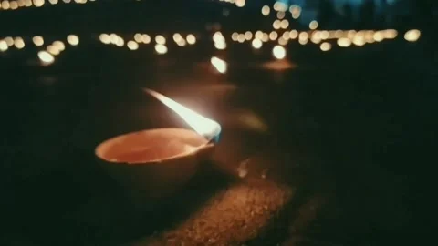 Flame of oil lamp blowing with wind in dark glitter background. Stock Footage 137496996