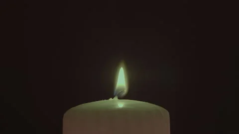 The flame of one candle in the dark, moving from a draft, close up Stock Footage 225536379