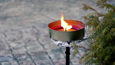 Flame shell with a bright yellow-orange flame and light reflecting wax Stock-Footage 70430159