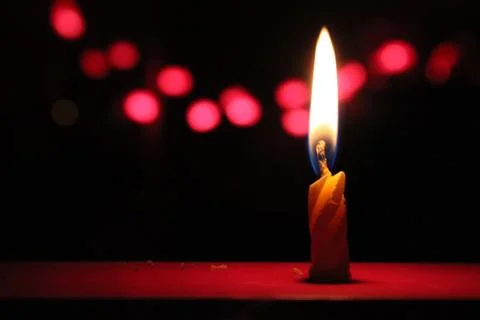 Flame of a small thin candle Stock Photos