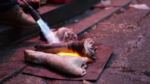 Flame Torch burning Pork Hands, Chinese Market, 1080p 50fps Stock Footage 108149643