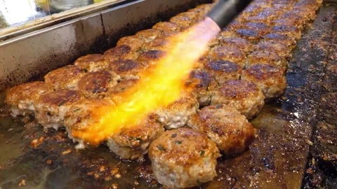 Flame-Torching Meatballs on a Flat-Top Griddle Stock Footage Video stock 343587264