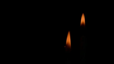 The flame of two candles burning in the dark Stock Footage 119944794