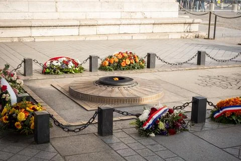 The flame of the unknown soldier under the arches of the Arc de Triomphe in.. Stock Photos
